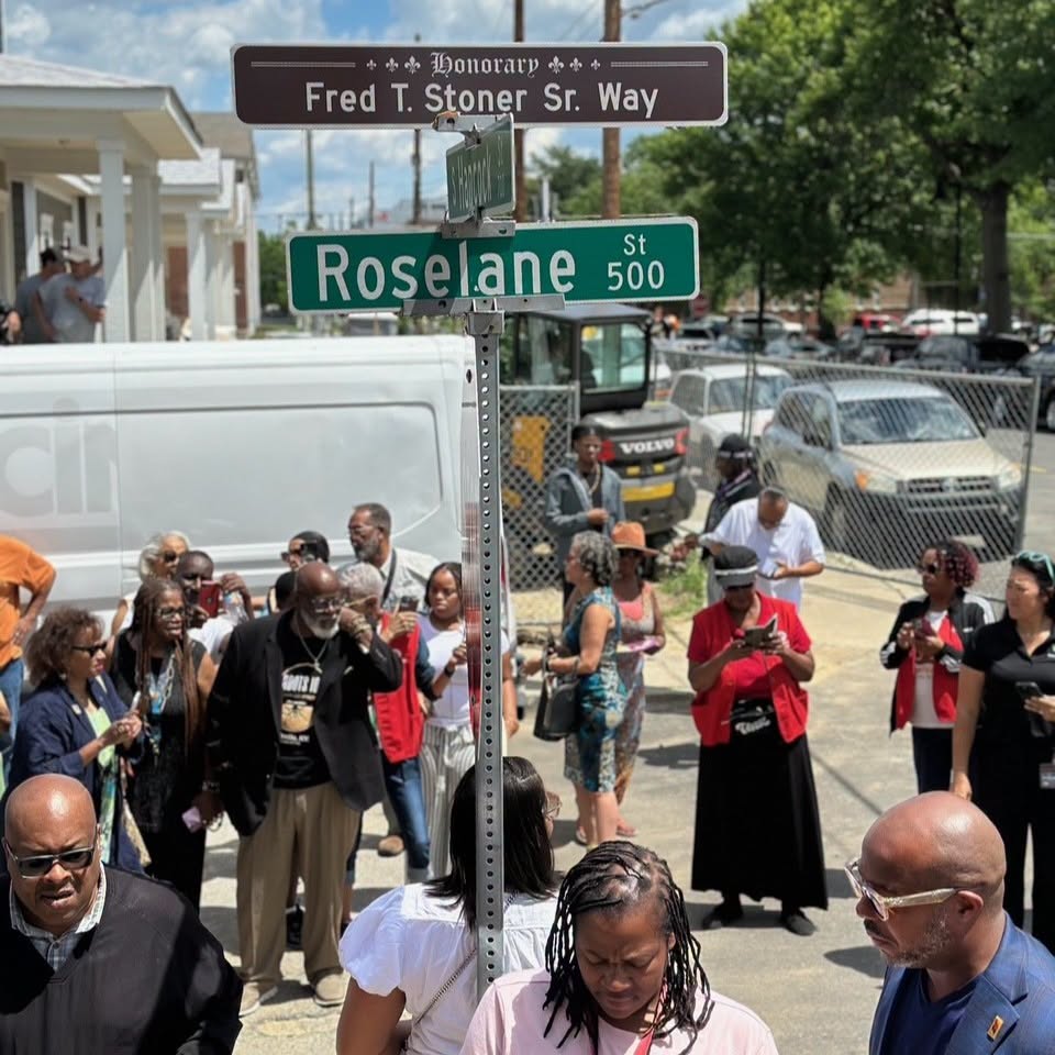 Crowd gathered beneath the Fred T. Stoner Sr. Way sign