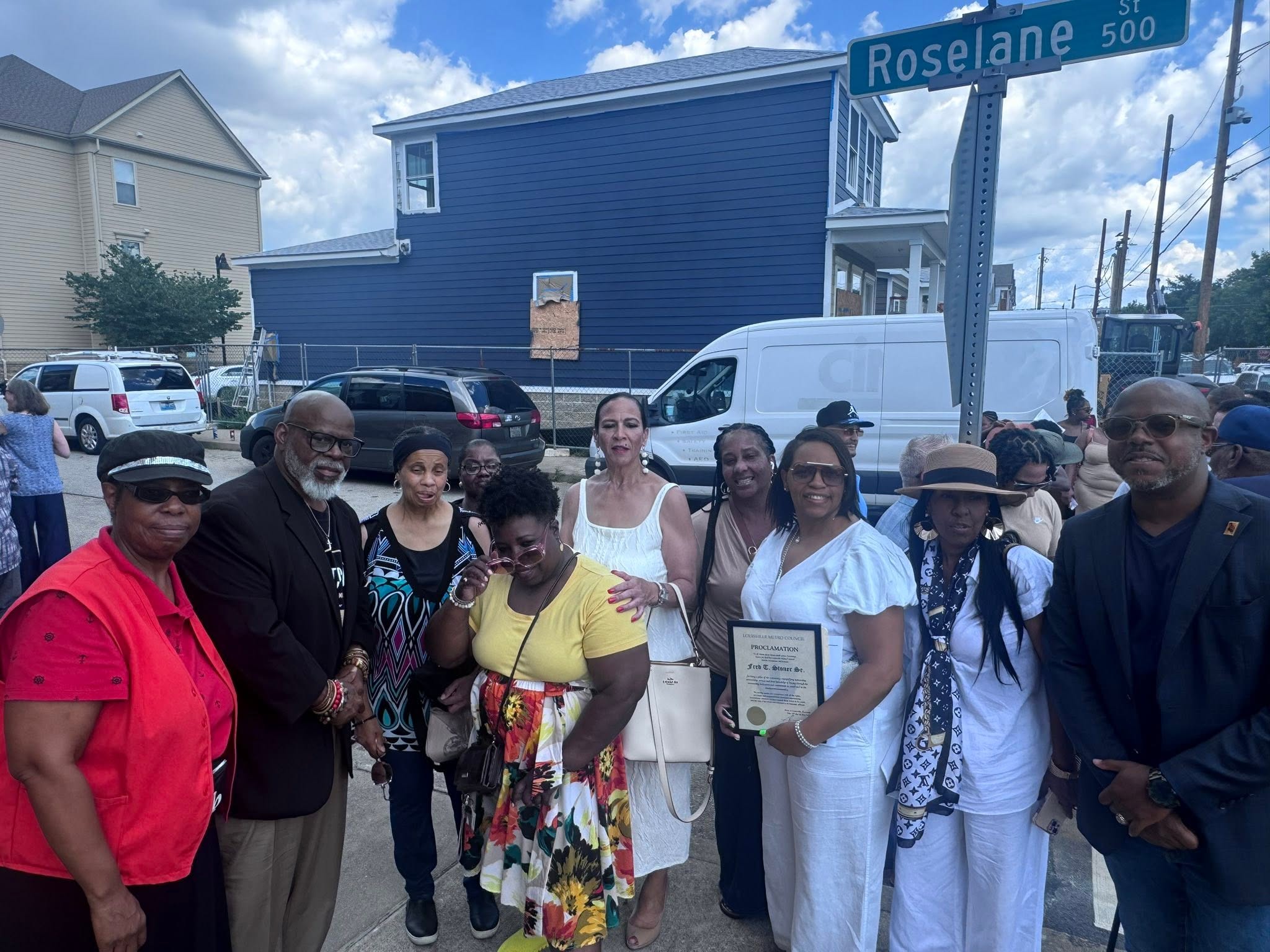Family and friends gathered near the Roselane St sign